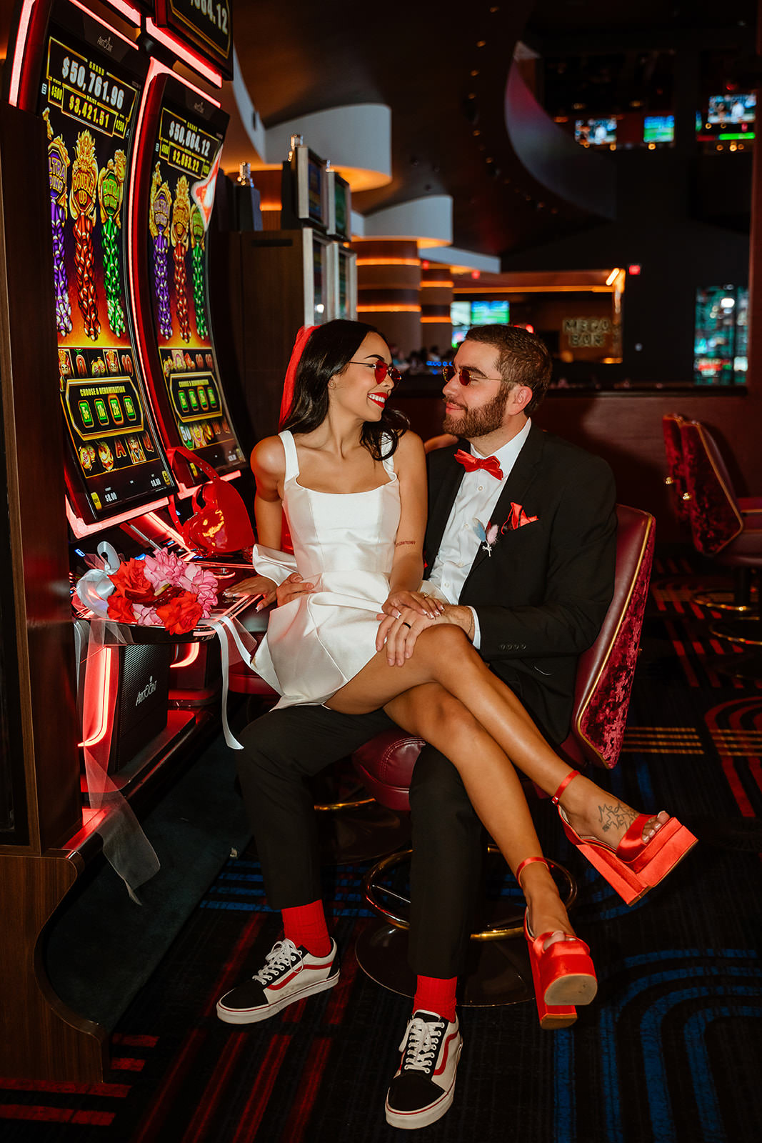 stylish couple at Las Vegas casino slot machines after wedding