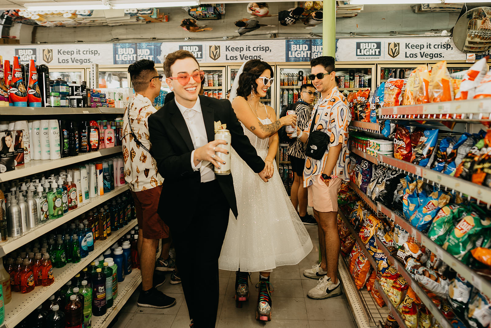 Las Vegas elopement couple celebrating in a convenience store with friends, candid wedding moment