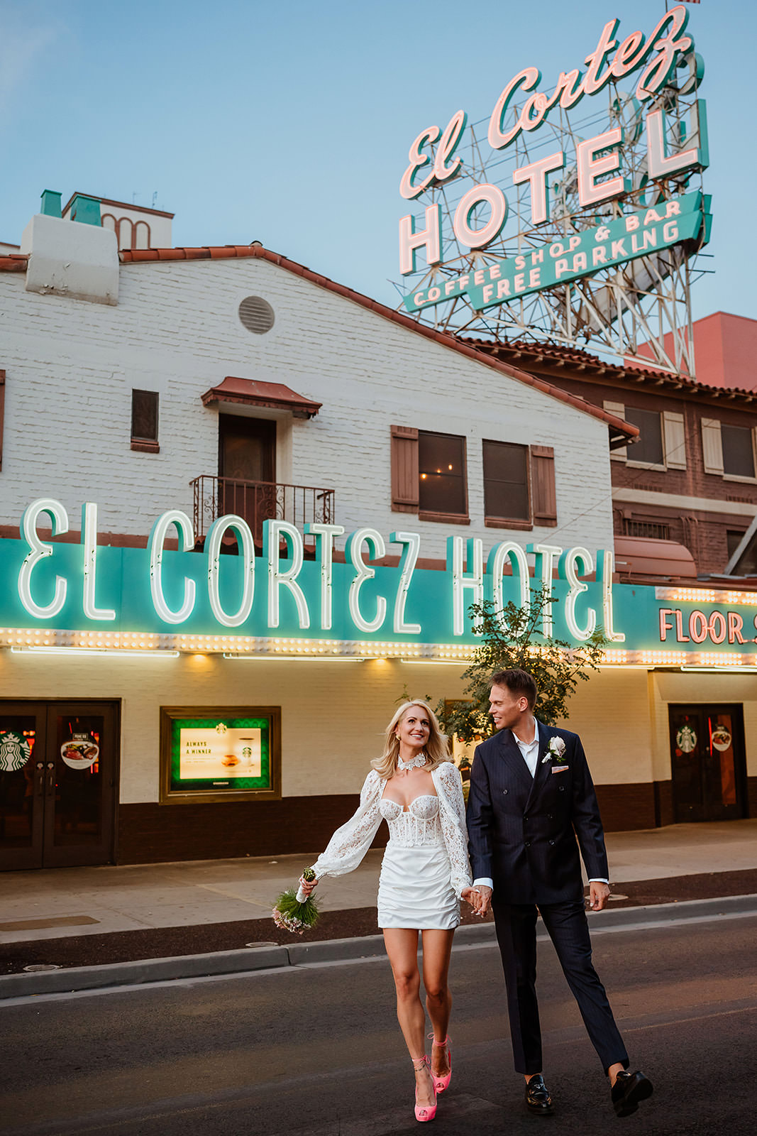 wedding couple walking in front of El Cortez Hotel sign in downtown Las Vegas