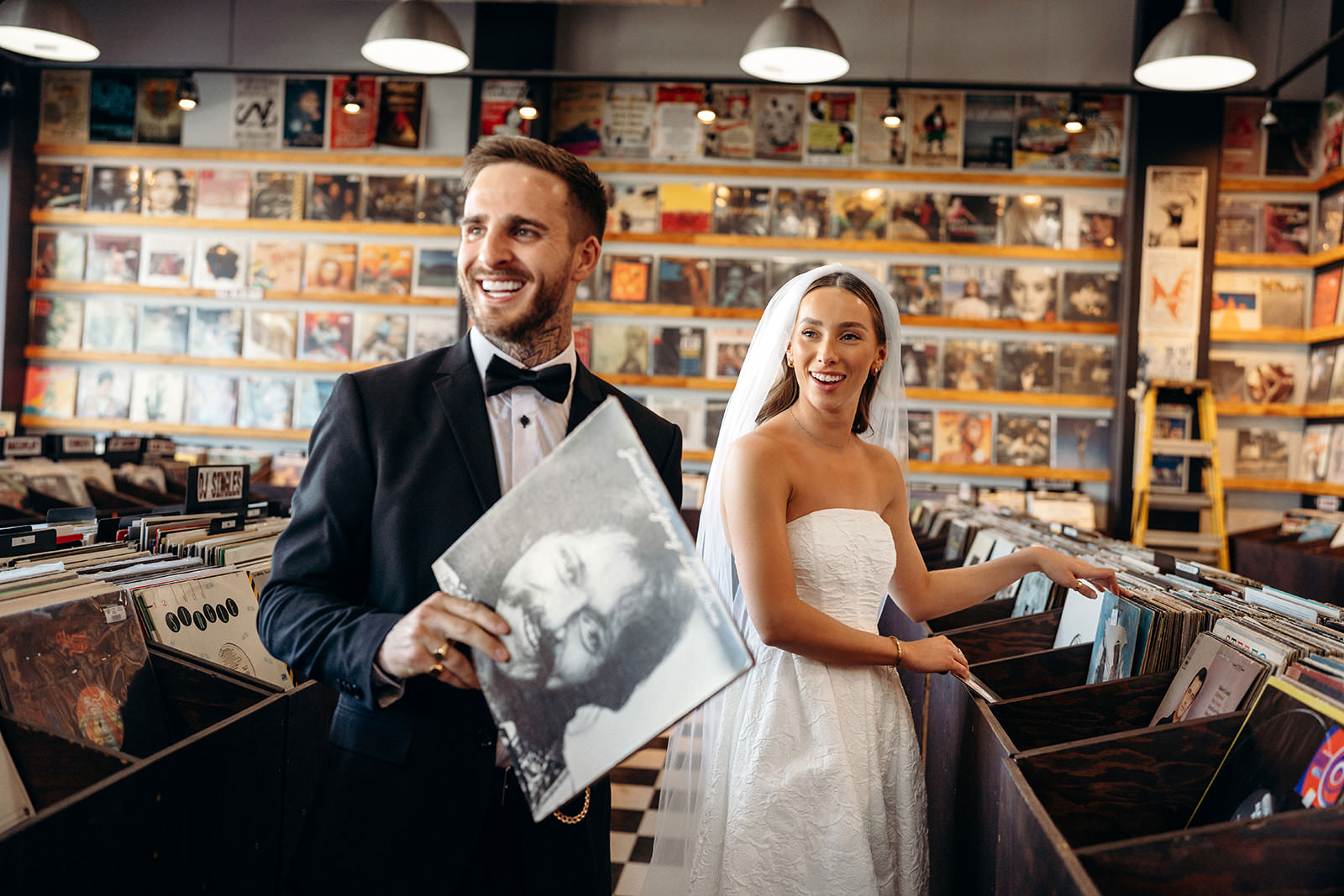 wedding couple browsing vinyl records in Las Vegas record store during elopement