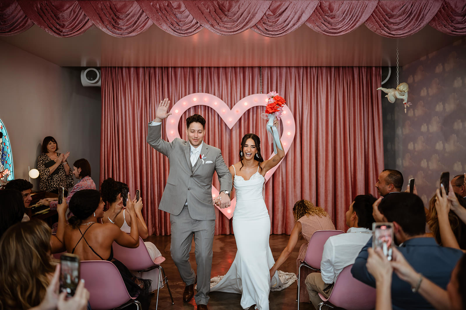 ouple walking down aisle after ceremony at Sure Thing Chapel Las Vegas heart altar wedding