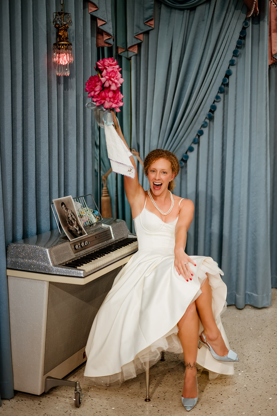 bride celebrating with bouquet at Sure Thing Too Chapel Las Vegas elopement