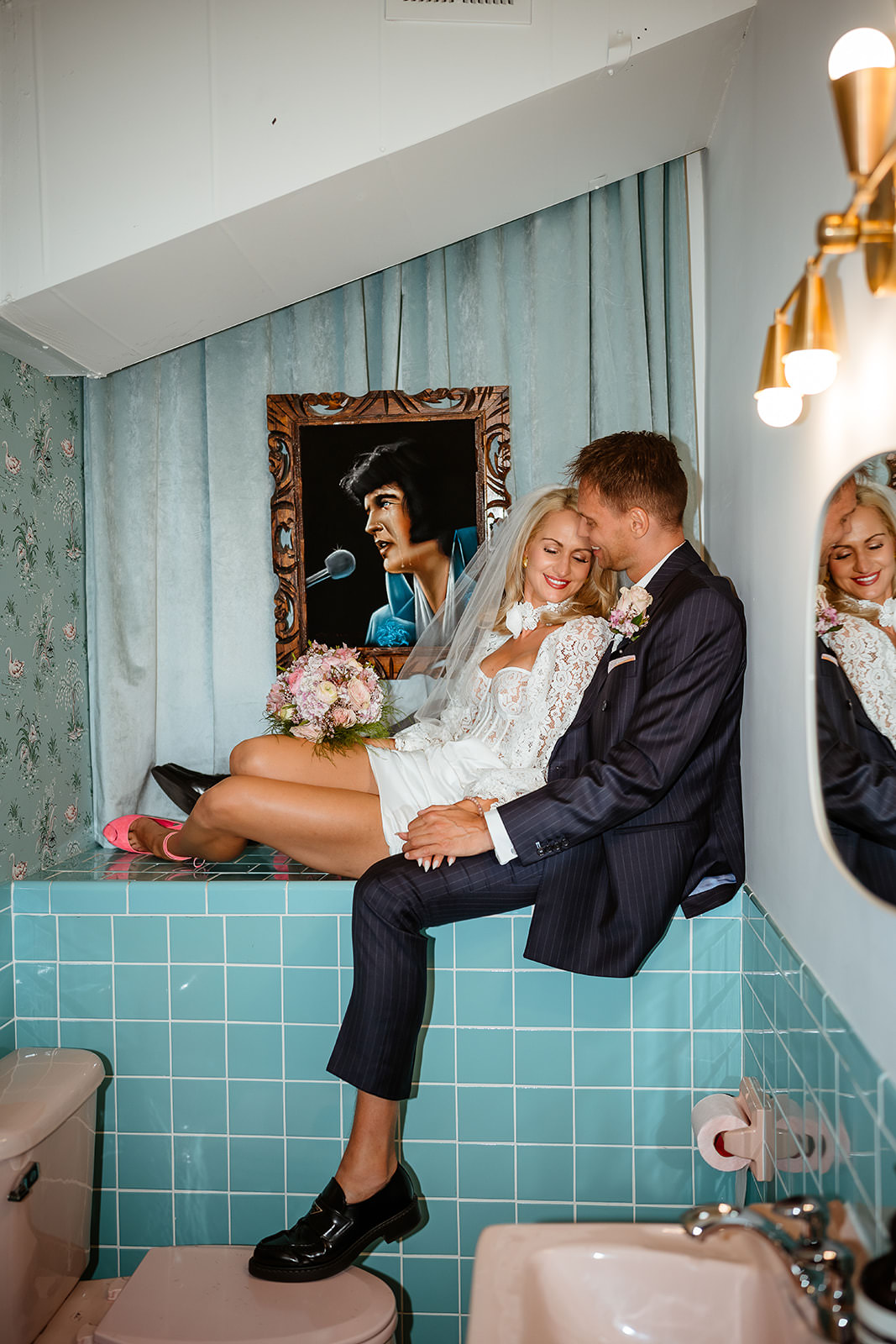 couple posing in vintage bathroom at Sure Thing Chapel Las Vegas elopement