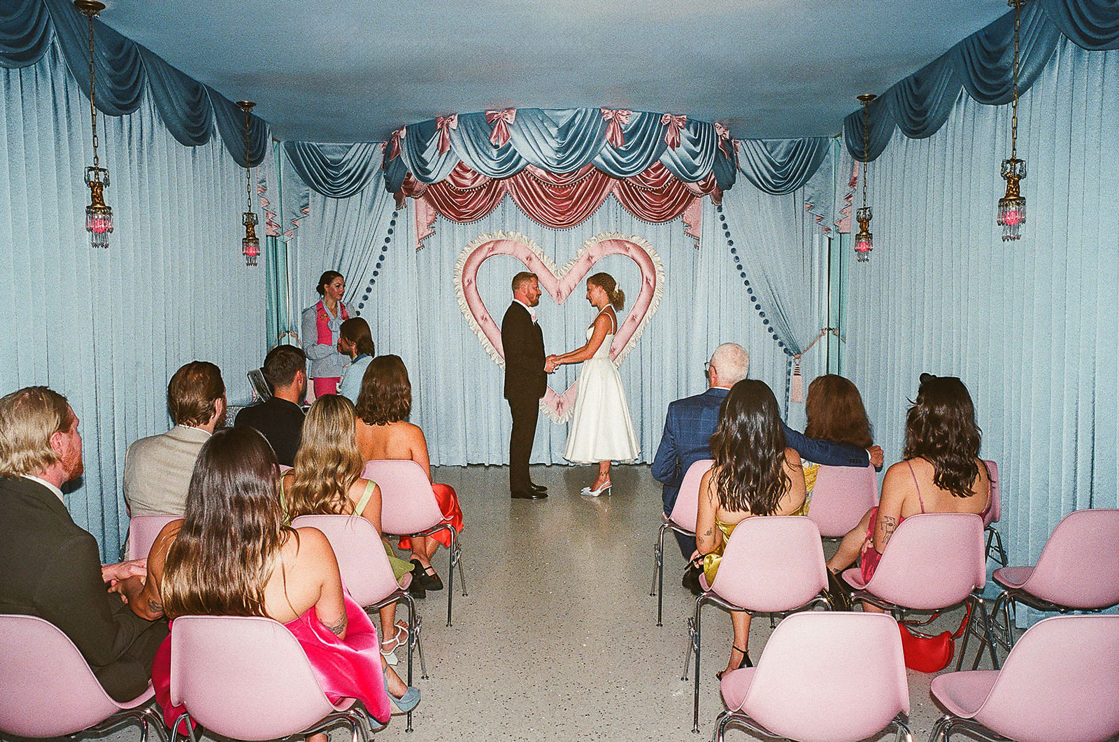 wide view of wedding ceremony with guests at Sure Thing Chapel Las Vegas heart altar